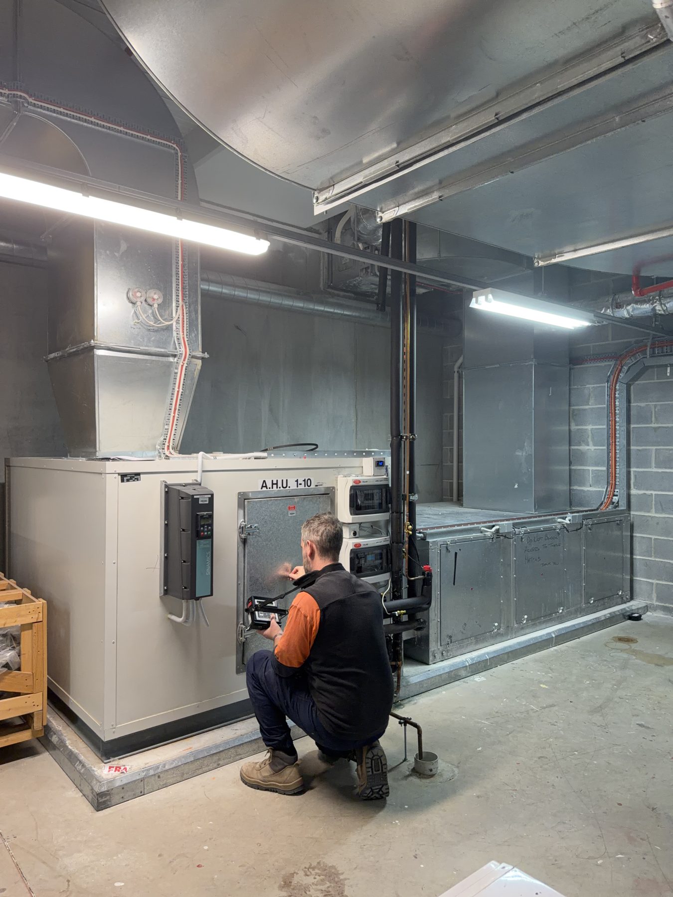 Technician commissioning an air handling unit