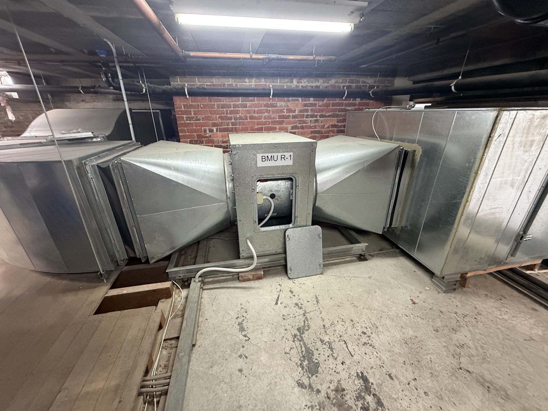 Supply and exhaust ductwork in a basement plant room